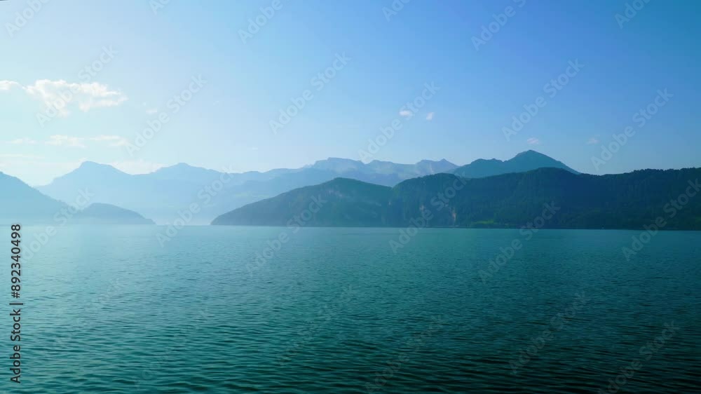 Calm Water, Blue Sky, and Distant Mountains in the Calm Lake Lucerne Calm Water, Blue Sky, and Distant Mountains in the Calm Lake Lucerne