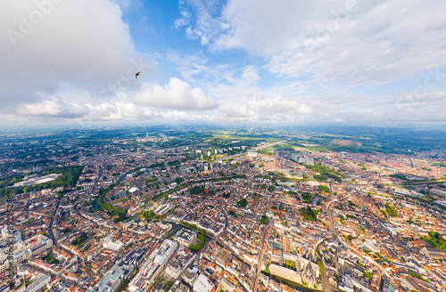 Ghent, Belgium. City center and surroundings. Residential and industrial areas. Panorama of the city. Summer day, cloudy weather. Aerial view