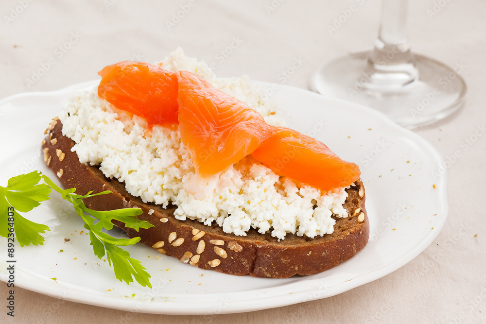 A sandwich with fish and other healthy snacks. Salmon bread food concept. A sandwich with cheese and curd next to fish. A sandwich with fish, cheese, and curds is a healthy lifestyle snack. A sandwich with fish and other healthy snacks. Salmon bread food concept. A sandwich with cheese and curd next to fish. A sandwich with fish, cheese, and curds is a healthy lifestyle snack.