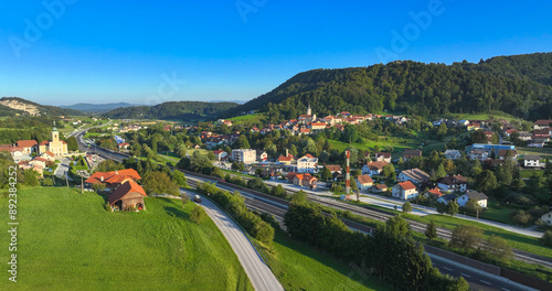 Εκτύπωση καμβά AERIAL: Flying above idyllic countryside and highway running past a small town