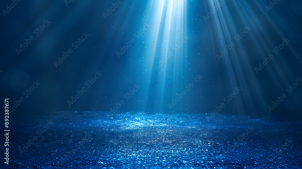 Fototapeta premium Blue light beams shining through water, creating a serene underwater scene.