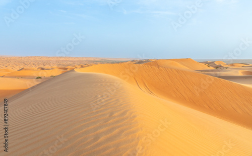 Big orange desert sand dunes in the middle of Wahiba desert, Oman photo