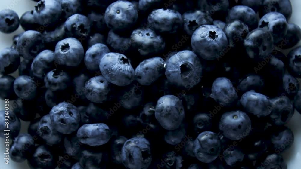 blueberries rotate on a white plate. Blueberries top view. harvesting. healthy food and vitamins. blueberries rotate on a white plate. Blueberries top view. harvesting. healthy food and vitamins.