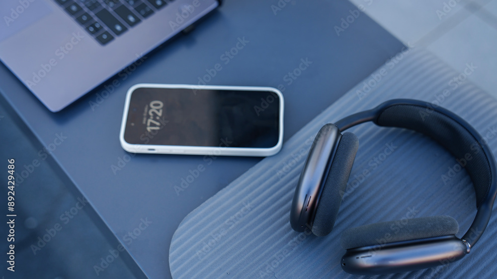 Creative top view flat lay of laptop, headphones and mobile phone background minimal style. Concept of modern accessories for travel adventures and life Creative top view flat lay of laptop, headphones and mobile phone background minimal style. Concept of modern accessories for travel adventures and life