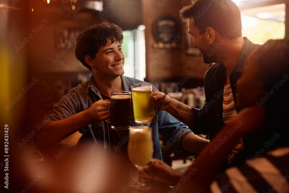 Happy men toasting with beer in pub. Happy men toasting with beer in pub.
