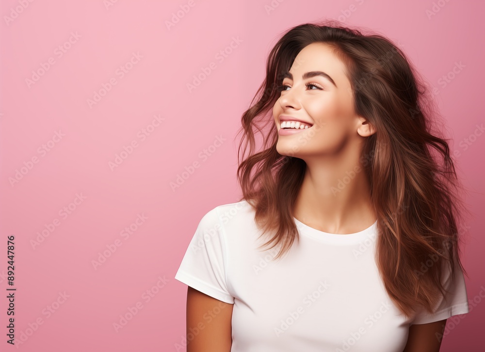 Portrait of a smiling beautiful woman in a white t-shirt looking away over a pink background with copy space, side view Portrait of a smiling beautiful woman in a white t-shirt looking away over a pink background with copy space, side view