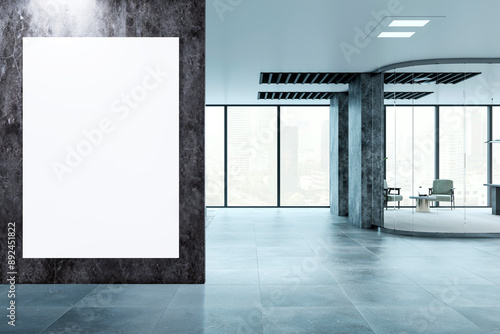 A modern office interior with a large white poster mockup on a marble wall, floor-to-ceiling windows, and a desk with a chair, on a cityscape background, concept of advertising space. 3D Rendering