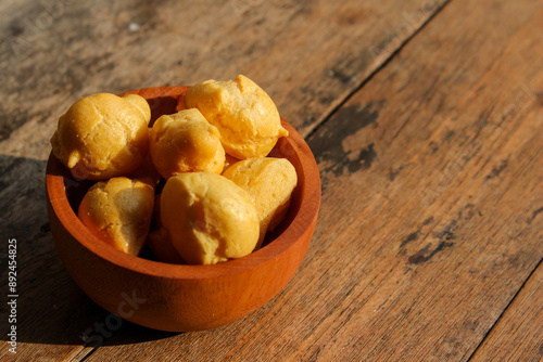 Dry Soes Cake in a small wooden bowl with wooden background photo