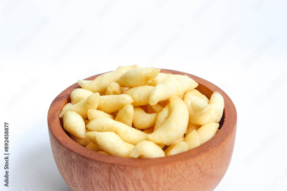 Crunchy Cheese Stick or Cheese Cork Eggs or Telur Gabus Keju or Widaran or Bidaran Keju on small wooden bowl isolated on white background Crunchy Cheese Stick or Cheese Cork Eggs or Telur Gabus Keju or Widaran or Bidaran Keju on small wooden bowl isolated on white background