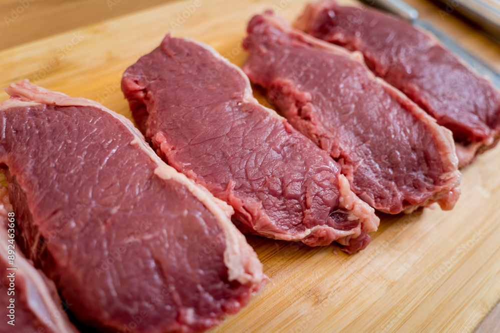 Raw fillet beef meat for steaks on the cutting board Raw fillet beef meat for steaks on the cutting board