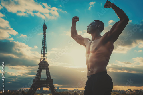 Black African American athlete with arms wide open celebrating his victory near the Eiffel Tower in Paris, France. photo