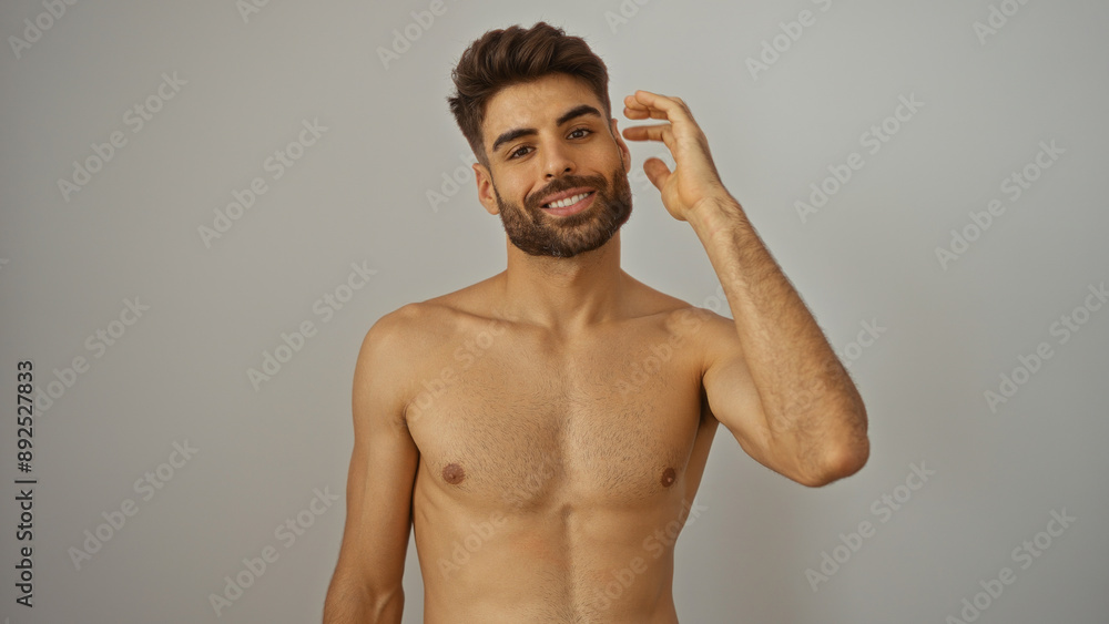 Fototapeta premium Shirtless young man with a beard smiling against an isolated white background wall