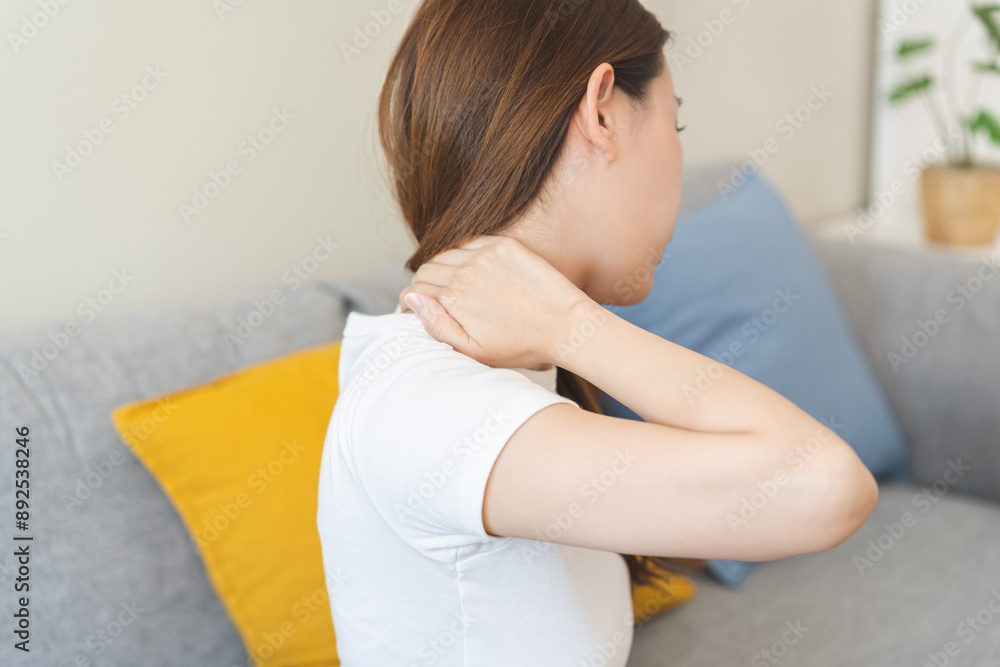 Pain body muscles stiff problem, asian young woman, girl painful with back, neck ache from work hand holding massaging rubbing shoulder hurt, sore sitting on couch at home. Health care and medicine. Pain body muscles stiff problem, asian young woman, girl painful with back, neck ache from work hand holding massaging rubbing shoulder hurt, sore sitting on couch at home. Health care and medicine.
