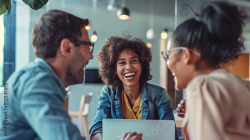 Multiracial Work Team Happily Discussing Project Content in a Bright and Simple Office, Captured for Corporate Recruitment or Team Presentation Purposes