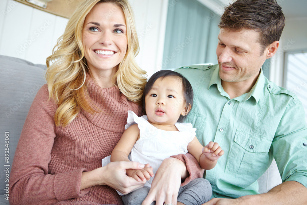 Love, happy family and foster baby in home for care, support or bonding together. Mother, father and cute adopted kid with parents for connection, diversity or interracial with toddler in living room Love, happy family and foster baby in home for care, support or bonding together. Mother, father and cute adopted kid with parents for connection, diversity or interracial with toddler in living room