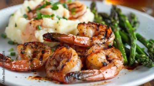 Plate of big grilled shrimp with a side of mashed potatoes and asparagus -