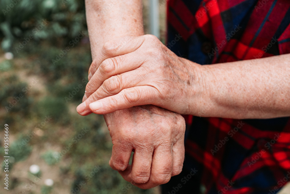 Fototapeta premium Elderly woman showing her hands joints