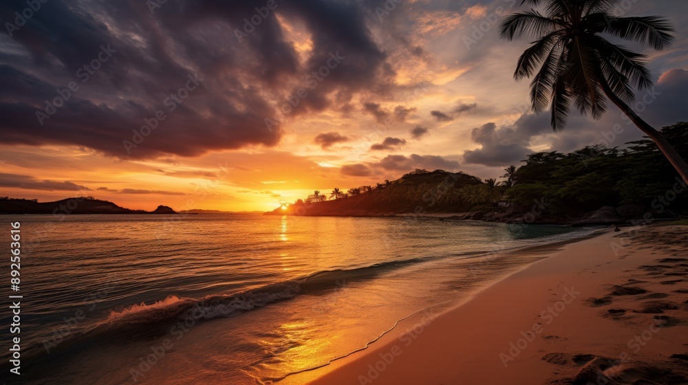 Sandy tropical beach at sunset with golden sky and island in the background Sandy tropical beach at sunset with golden sky and island in the background