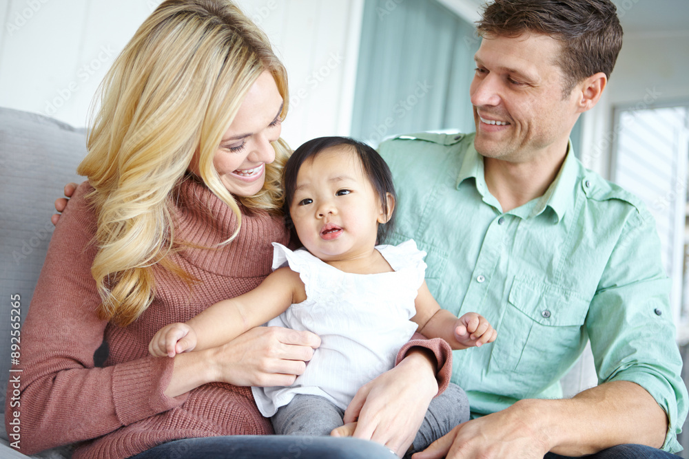 Care, happy family and foster baby in home for love, support or bonding together. Mother, father and cute adopted kid with parents for connection, interracial and diversity with child in living room Care, happy family and foster baby in home for love, support or bonding together. Mother, father and cute adopted kid with parents for connection, interracial and diversity with child in living room