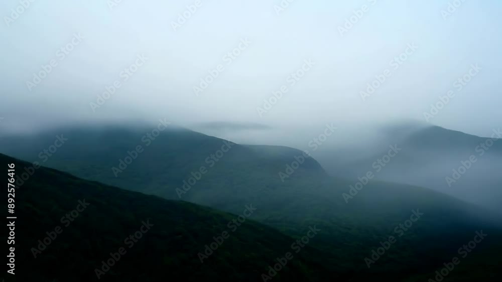 Misty mountain landscape shrouded in fog