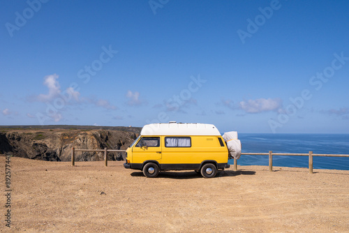 Retro camper van parked on the cliffs on Cordoama beach in Portugal