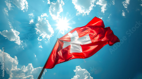Swiss National Day The Swiss flag flies against a bright blue sky with clouds, symbol national pride. The vivid image is suitable for patriotic and cultural themes. Style for national holidays 