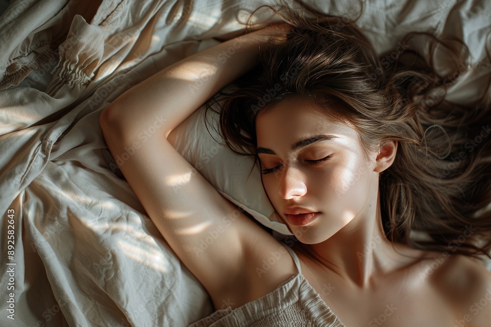A woman is sleeping on a bed with her head resting on a pillow. The image has a calm and peaceful mood, as the woman is in a relaxed state A woman is sleeping on a bed with her head resting on a pillow. The image has a calm and peaceful mood, as the woman is in a relaxed state