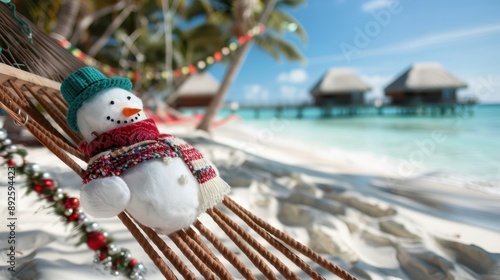 A cheerful snowman wearing a scarf and hat is relaxing on a hammock at a tropical beach, juxtaposing winter elements with a summer setting in a playful scene. photo