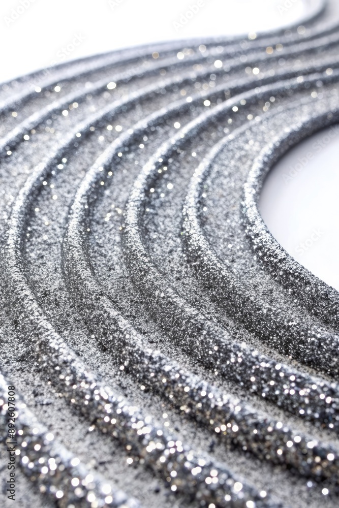 Naklejka premium Spiraling pattern of shiny silver beads in a circular arrangement.