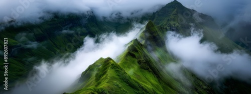  A bird's-eye perspective of a green mountain, clouds in front, peak up top