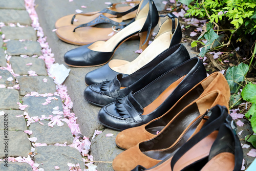 lady shoes for sale on a curbstone at a flea market photo