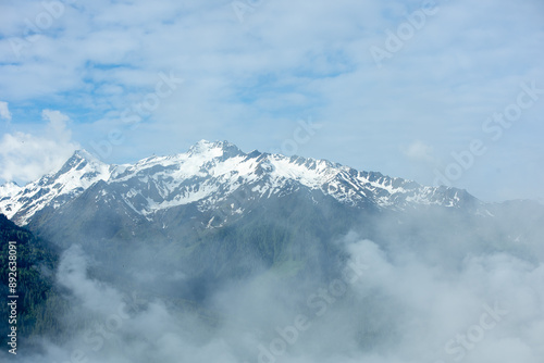 Landscape of valley with traditional wooden houses in Bramberg am Wildkogel