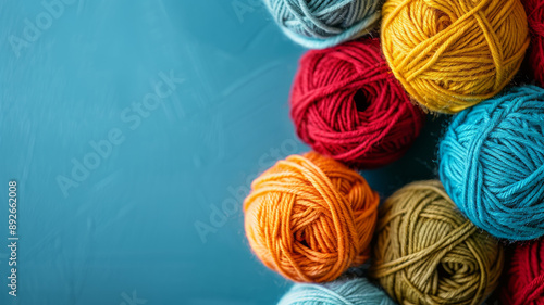 Colorful balls of yarn on a blue background.