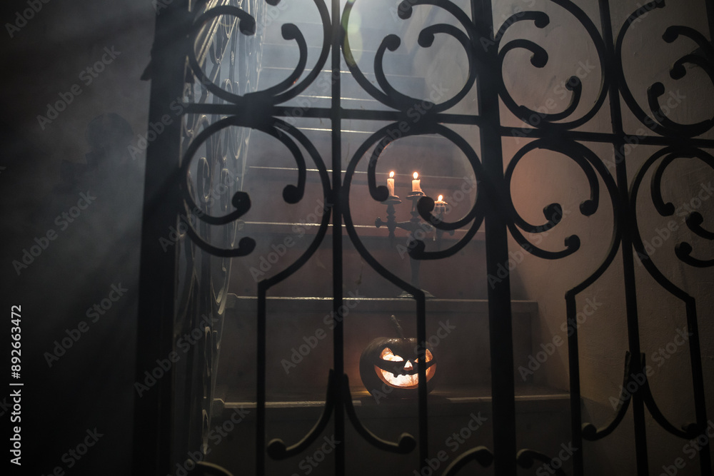 Inside of old creepy abandoned mansion. Silhouette of horror ghost standing on castle stairs to the basement. Spooky dungeon stone stairs in old castle with light. Horror Halloween concept