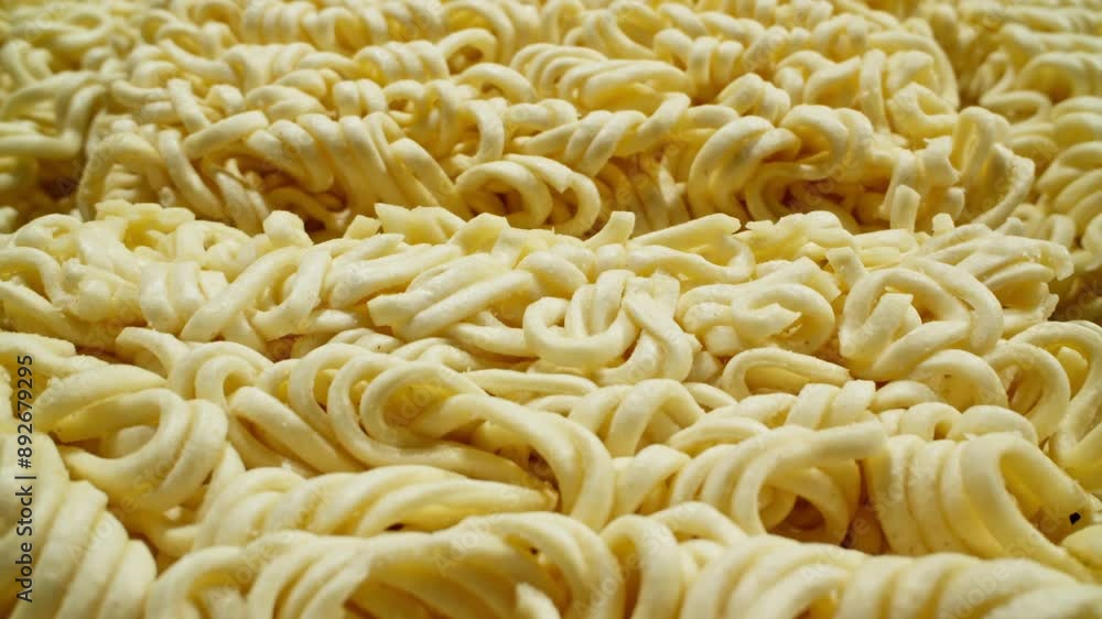 Large quantity of instant ramen noodles showcasing their curled shape. Precooked dehydrate noodle blocks. Asian food. Dolly shot with macro shot. Close-up in 4K, UHD Large quantity of instant ramen noodles showcasing their curled shape. Precooked dehydrate noodle blocks. Asian food. Dolly shot with macro shot. Close-up in 4K, UHD