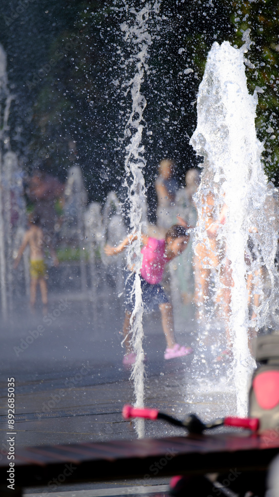 Fototapeta premium Joyful Sprinkler Splash. Splashing into Summer Fun.
