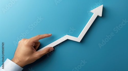 A Hand Guiding an Upward Arrow on a Blue Background