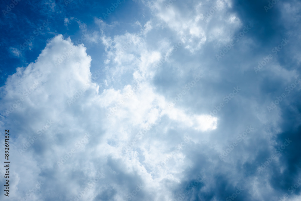 The sky is blue with a few clouds scattered throughout. The clouds are white and fluffy, giving the sky a peaceful and serene appearance The sky is blue with a few clouds scattered throughout. The clouds are white and fluffy, giving the sky a peaceful and serene appearance