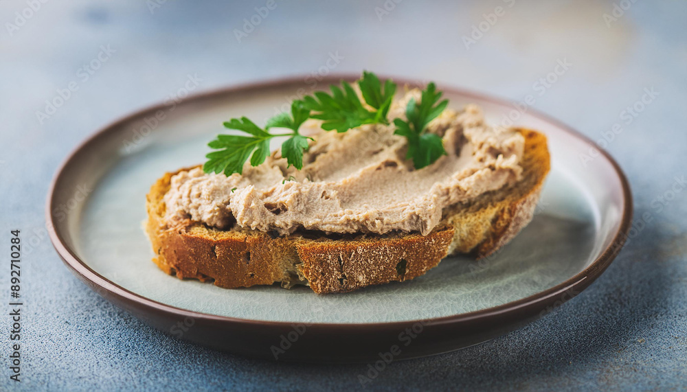 Crusty bread generously spread with smooth liver pate and fresh herbs. Tasty snack for lunch Crusty bread generously spread with smooth liver pate and fresh herbs. Tasty snack for lunch