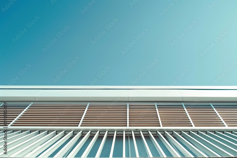 Obraz premium Close-Up of Industrial Building Roof with Light Brown Tiles and White Vertical Stripes Against Blue Sky with Clouds