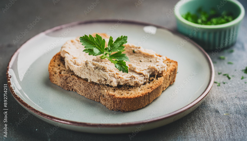 Crusty bread generously spread with smooth liver pate and fresh herbs. Tasty snack for lunch Crusty bread generously spread with smooth liver pate and fresh herbs. Tasty snack for lunch