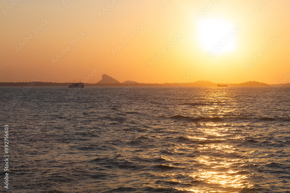 Fototapeta premium beautiful dramatic landscape of sunset on sea beach with silhouette of boat