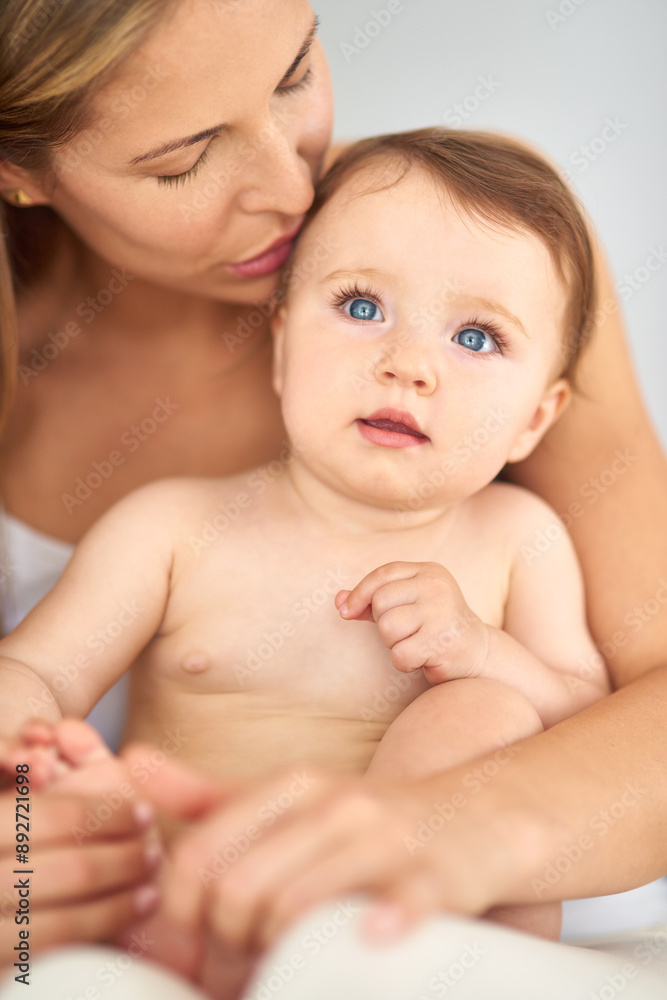 Mother, baby and kiss in home for learning, care and support for growth and relax or kid. Development, memory and family in house or lounge for love, child and bonding together for trust in morning Mother, baby and kiss in home for learning, care and support for growth and relax or kid. Development, memory and family in house or lounge for love, child and bonding together for trust in morning