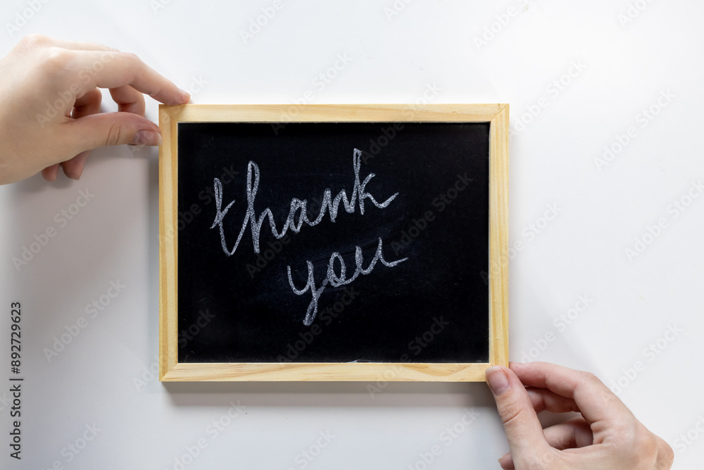 Top view of the inscription “Thank you”, written on a school blackboard Top view of the inscription “Thank you”, written on a school blackboard