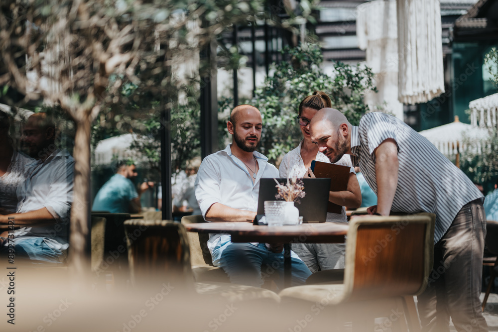 Business workers collaborating together in a coffee bar, brainstorming ideas and sharing knowledge for solutions, working remotely. Business workers collaborating together in a coffee bar, brainstorming ideas and sharing knowledge for solutions, working remotely.