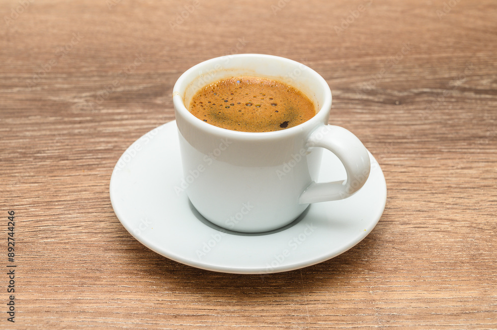 Turkish coffee in modern coffee cup on wooden table Turkish coffee in modern coffee cup on wooden table