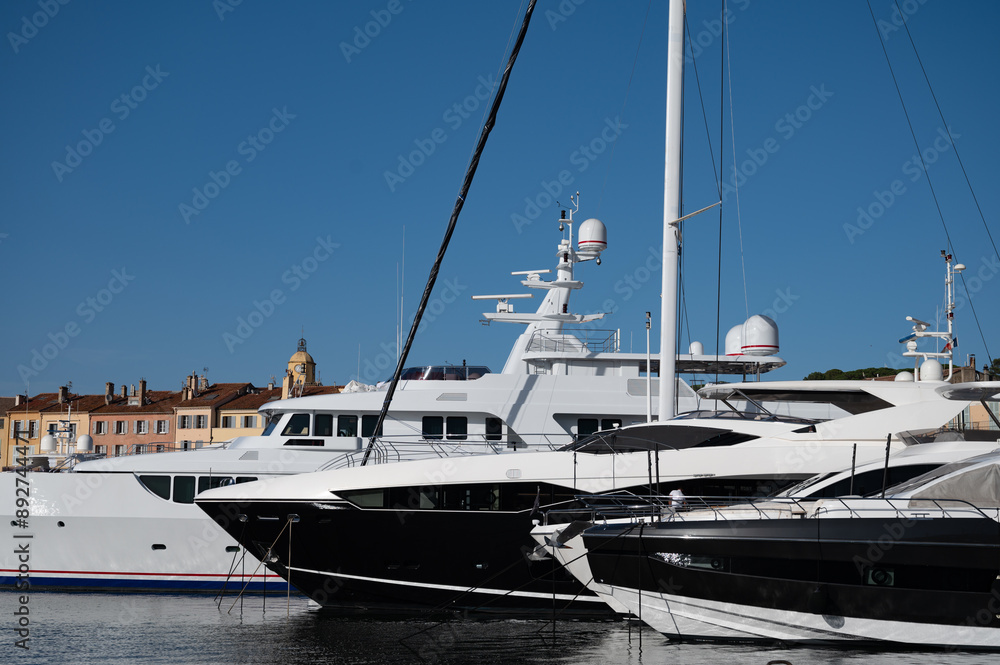 Fototapeta premium Old port of Saint-Tropez famous touristic village on French Riviera, summer vacation with large yacht boats and colorful houses