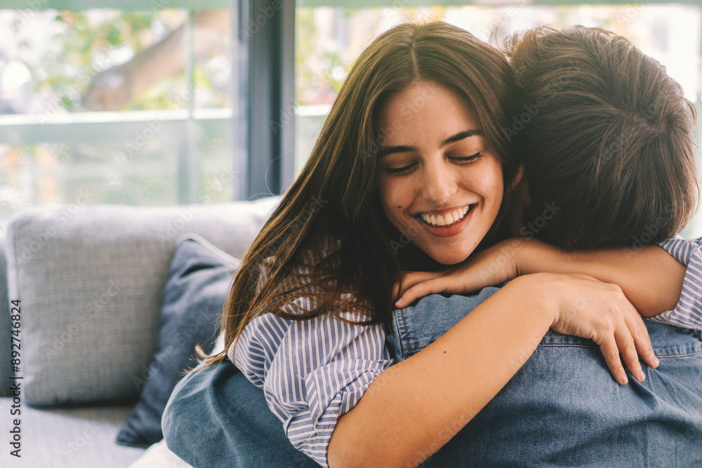 Happy couple in relationship hugging each other after separation long time for problems. One adult woman embrace boyfriend or brother on the sofa at home. Love and feeling in people. Embracing Happy couple in relationship hugging each other after separation long time for problems. One adult woman embrace boyfriend or brother on the sofa at home. Love and feeling in people. Embracing