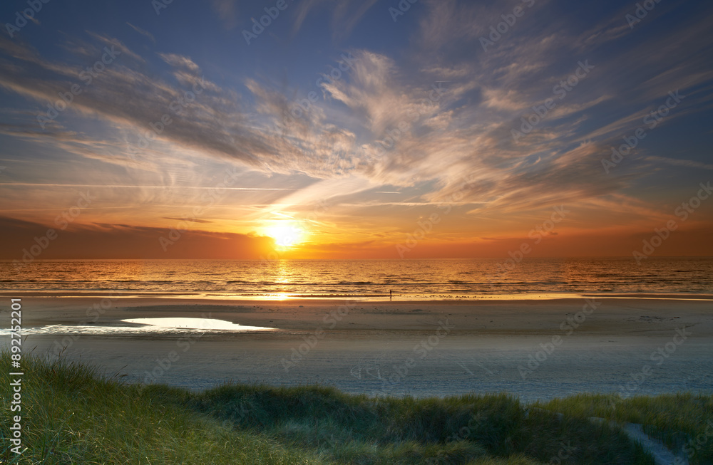 Obraz premium Environment, sky and sunset at beach with clouds in season for summer holiday, travel or vacation. Earth, grass and sea with horizon on ocean for background, nature or tropical island reflection