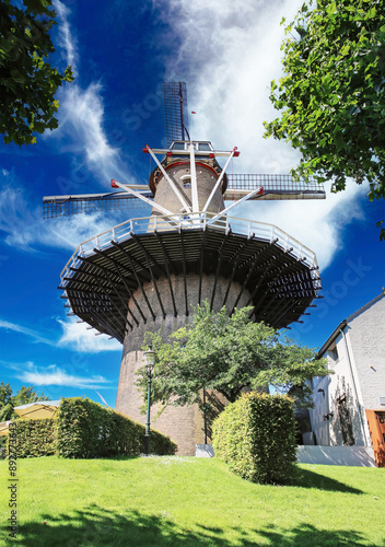 Ravenstein, Netherlands (Noord-Brabant) - July 9. 2024: Beautiful traditional dutch windmill Windmolen de Nijverheid in old town photo